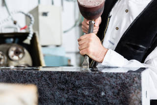 Stonemason working on marble headstone